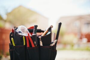 bag-of-tools-with-home-in-background