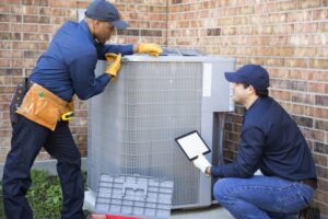 two-technicians-working-on-air-conditioner 